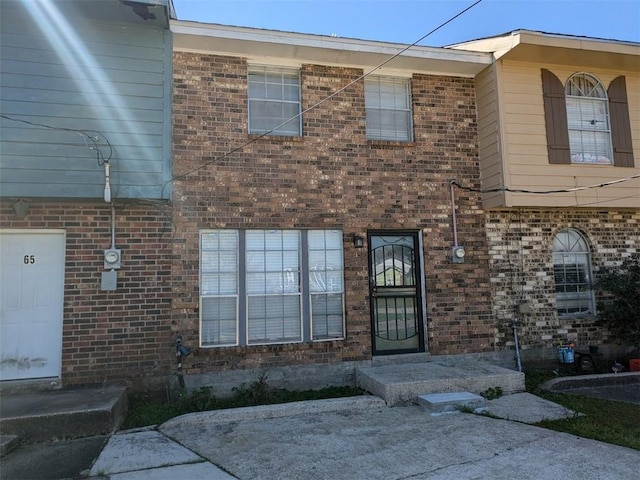 exterior space featuring brick siding