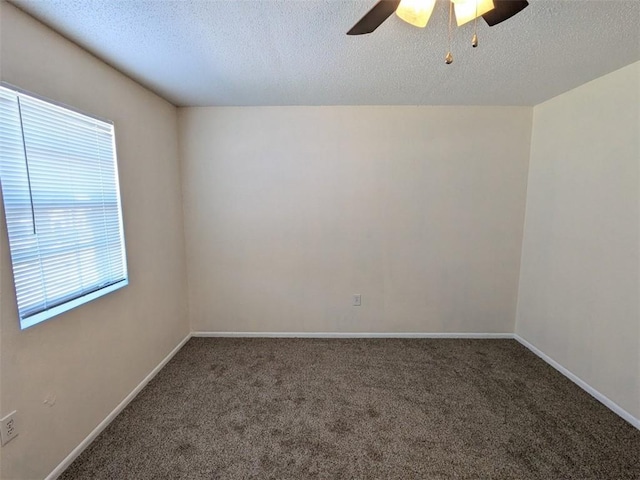 spare room featuring carpet flooring, ceiling fan, a textured ceiling, and baseboards