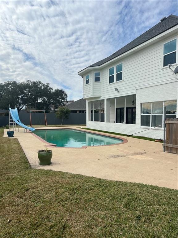 view of swimming pool with a fenced in pool, a water slide, a patio, and fence