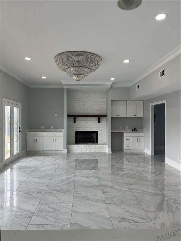 unfurnished living room with marble finish floor, baseboards, visible vents, and crown molding