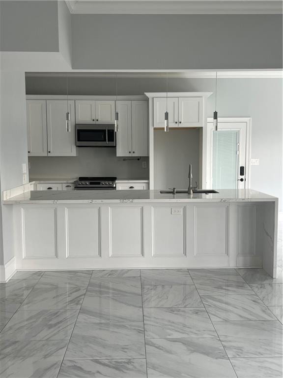 kitchen featuring electric stove, light countertops, stainless steel microwave, white cabinets, and a sink