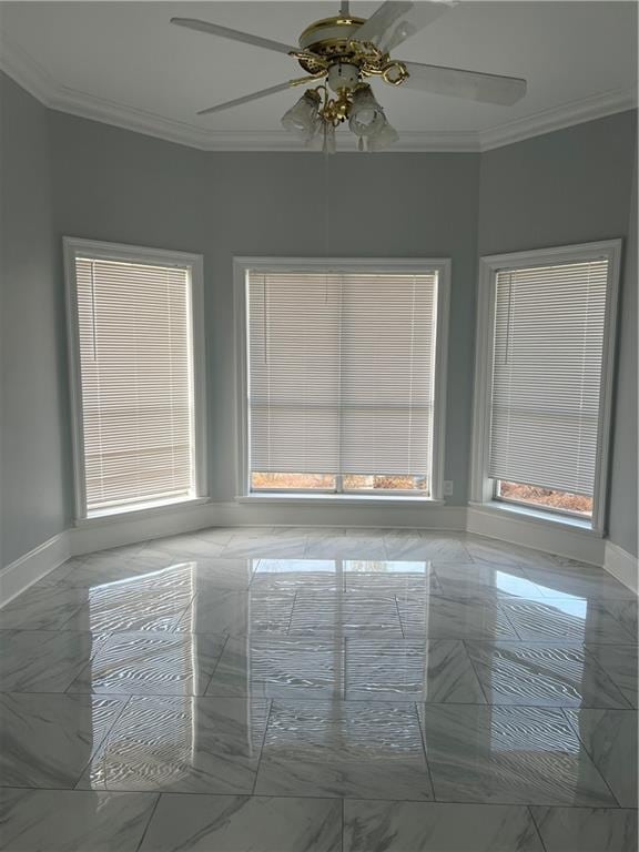 unfurnished room featuring marble finish floor, baseboards, and ornamental molding