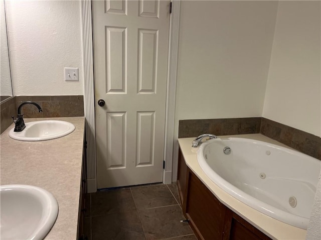 bathroom featuring tile patterned floors, a bathtub, and vanity