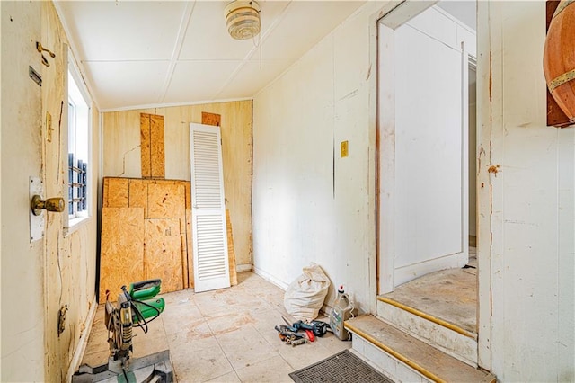 interior space featuring wood walls and vaulted ceiling