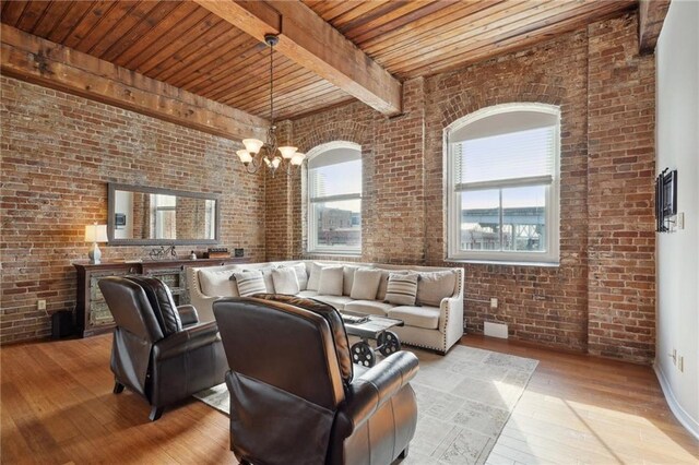 living room featuring brick wall and a chandelier