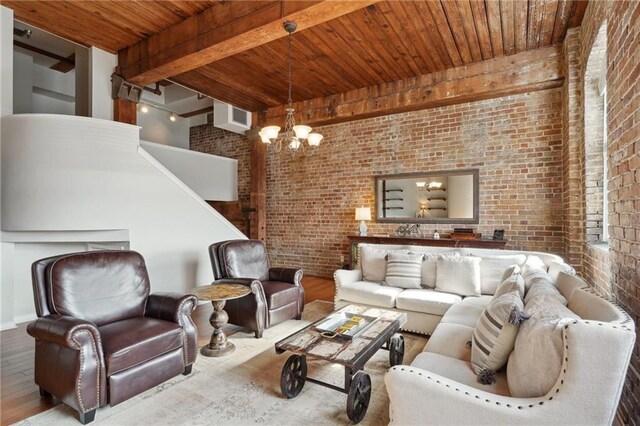 living room with brick wall, beam ceiling, and a chandelier