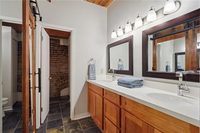 bathroom featuring toilet and vanity