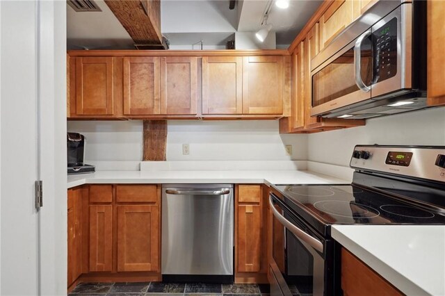 kitchen featuring track lighting and stainless steel appliances