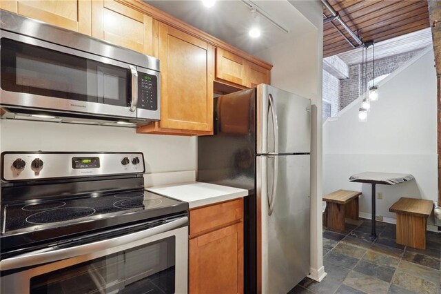 kitchen with rail lighting and stainless steel appliances