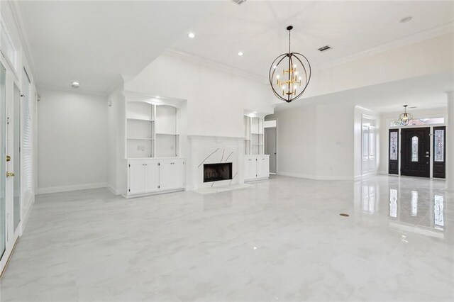 unfurnished living room featuring a high end fireplace, crown molding, and a chandelier