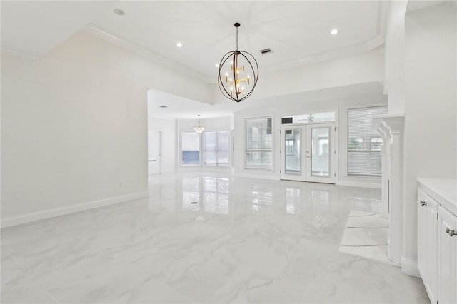 unfurnished living room with ceiling fan with notable chandelier, french doors, and crown molding