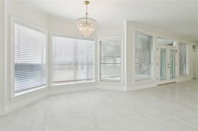 spare room with french doors, an inviting chandelier, and crown molding