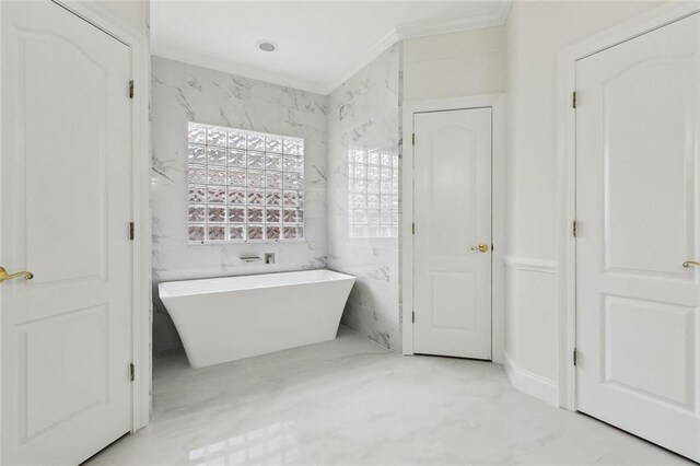 bathroom featuring a tub to relax in and crown molding