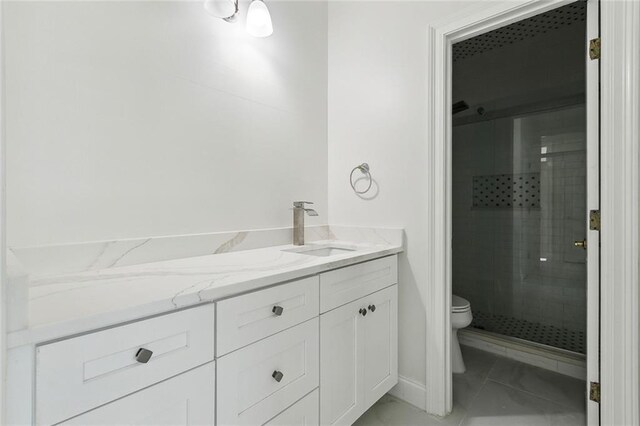 bathroom with toilet, an enclosed shower, tile patterned floors, and vanity