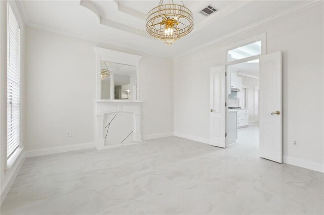 unfurnished room with a raised ceiling, crown molding, and an inviting chandelier