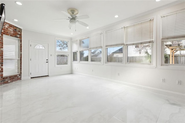 interior space with ceiling fan, a wealth of natural light, and crown molding