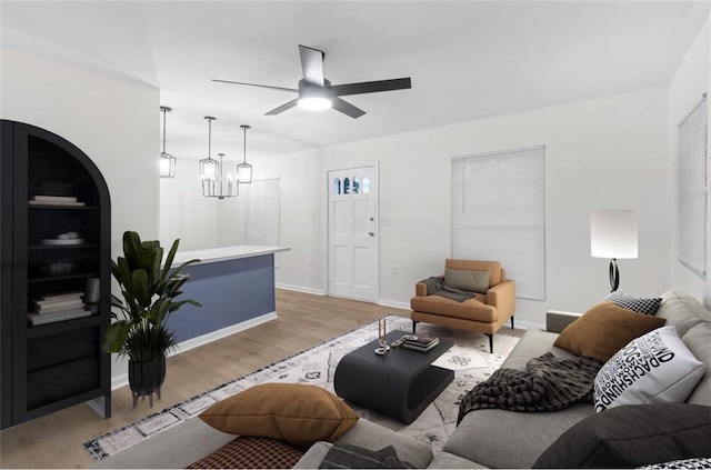 living room with ceiling fan and light hardwood / wood-style flooring