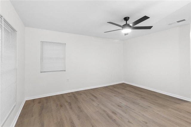 unfurnished room with hardwood / wood-style flooring and ceiling fan