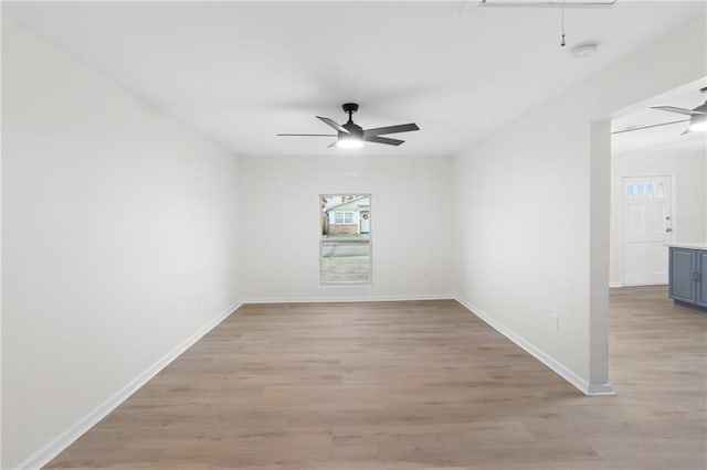 unfurnished room with ceiling fan and light wood-type flooring