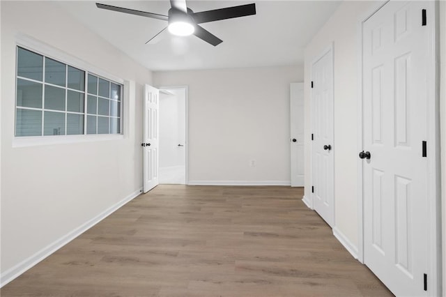 hallway with light hardwood / wood-style flooring