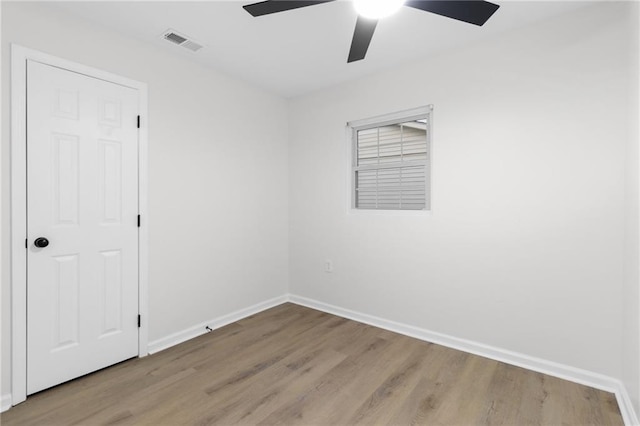 spare room with light hardwood / wood-style flooring and ceiling fan