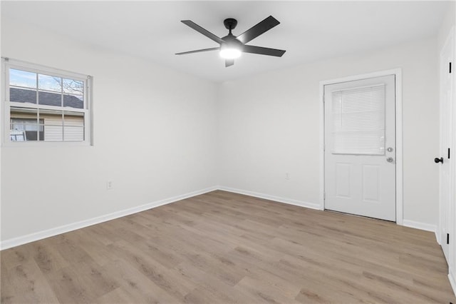 spare room with ceiling fan and light wood-type flooring