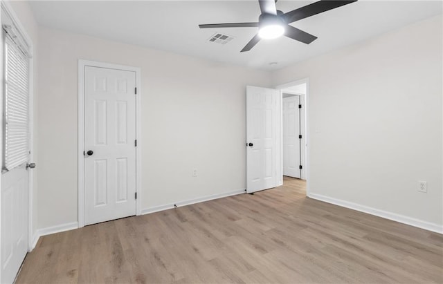 unfurnished bedroom with ceiling fan and light wood-type flooring