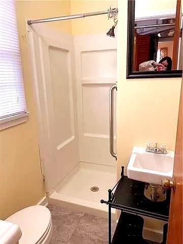 bathroom with sink, toilet, and walk in shower