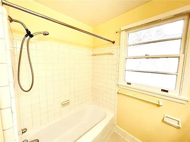 bathroom with tile patterned flooring and tiled shower / bath combo