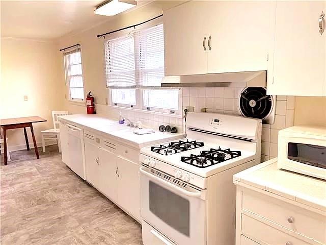 kitchen featuring white appliances and white cabinets