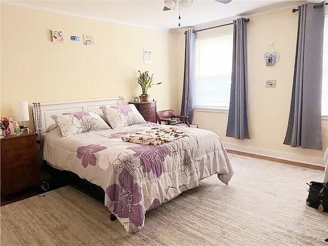 bedroom with ceiling fan and light hardwood / wood-style flooring