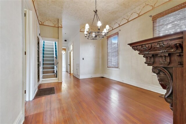 foyer entrance featuring a notable chandelier and hardwood / wood-style floors