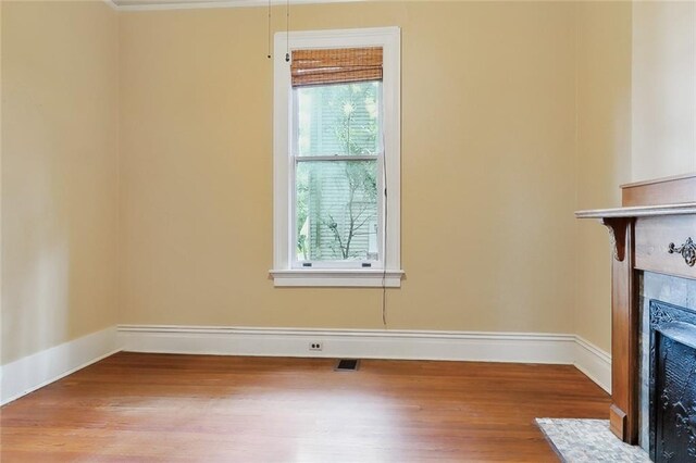 interior space with a tile fireplace, hardwood / wood-style floors, and plenty of natural light