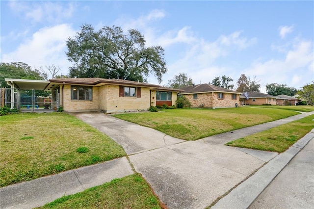 ranch-style house with a carport and a front yard