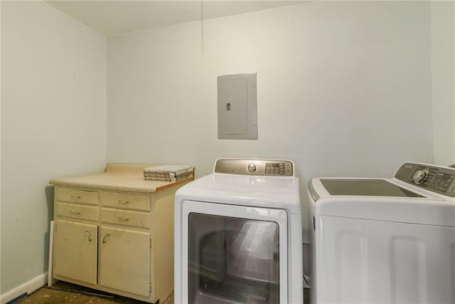 washroom featuring cabinets, independent washer and dryer, and electric panel