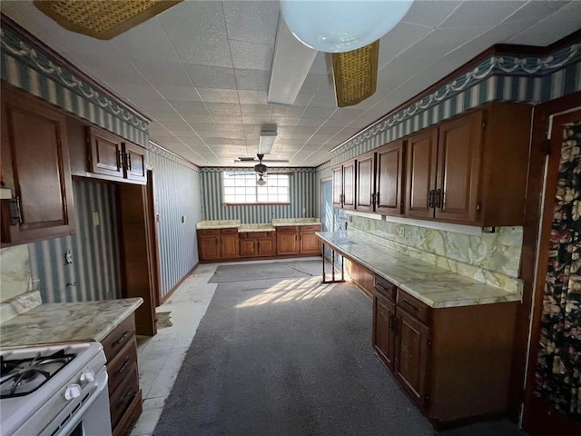 kitchen with ceiling fan and white gas range oven