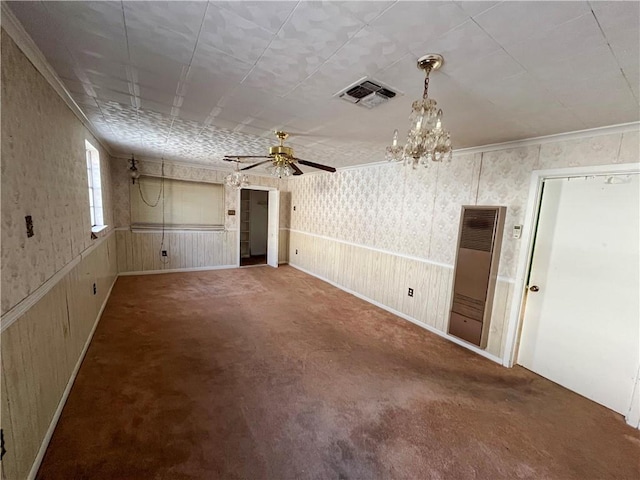 carpeted empty room with crown molding and ceiling fan with notable chandelier