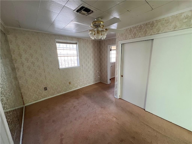 unfurnished bedroom with carpet floors, ornamental molding, a closet, and ceiling fan