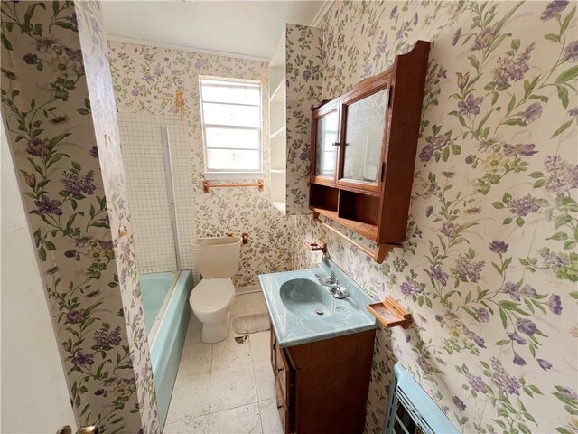 full bathroom with crown molding, combined bath / shower with glass door, tile patterned flooring, vanity, and toilet