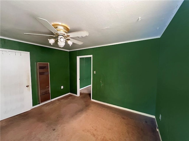 carpeted empty room with crown molding and ceiling fan