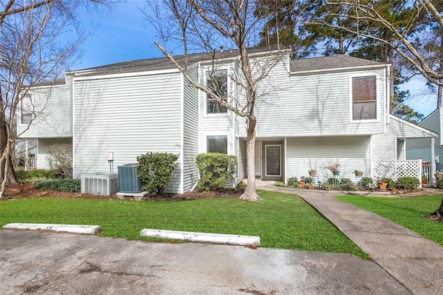 view of front facade with a front lawn and cooling unit