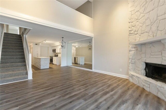 unfurnished living room featuring dark hardwood / wood-style flooring and a fireplace