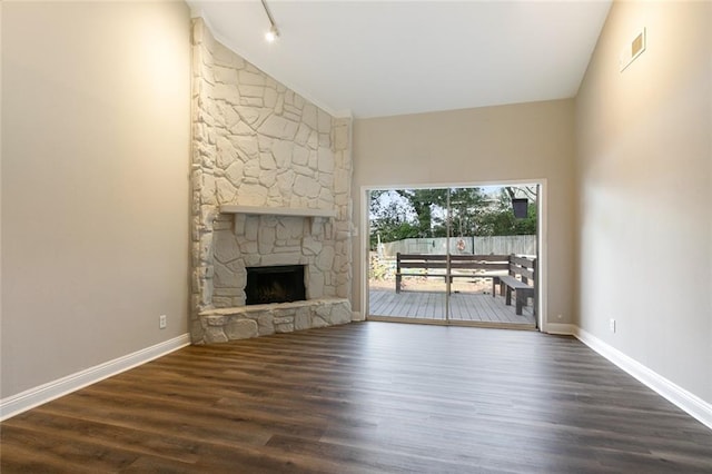 unfurnished living room featuring high vaulted ceiling, a fireplace, and dark hardwood / wood-style floors