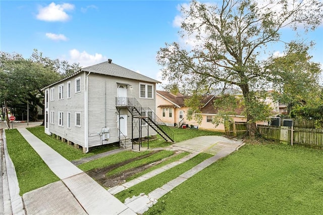 rear view of property featuring a yard