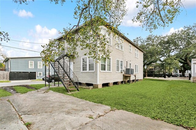 view of home's exterior with central AC and a lawn