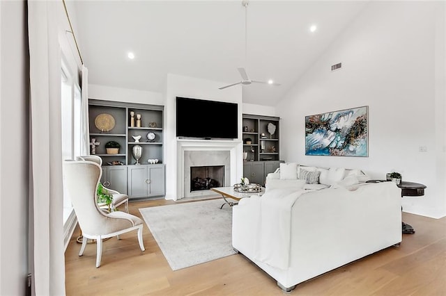 1012 Athania Pkwy, Metairie, LA 70001 - living area featuring light wood-style flooring, a high end fireplace, lofted ceiling, a ceiling fan, and recessed lighting