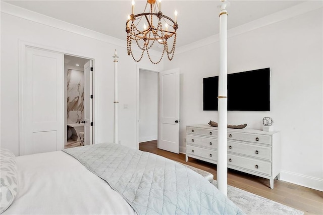 bedroom with wood finished floors, baseboards, a chandelier, and ornamental molding