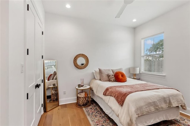 bedroom featuring a ceiling fan, light wood-style flooring, recessed lighting, and baseboards