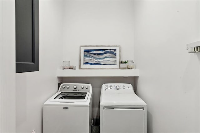 laundry room featuring separate washer and dryer and laundry area