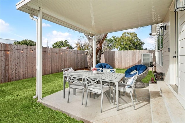 view of patio / terrace featuring a fenced backyard, central AC, and outdoor dining space